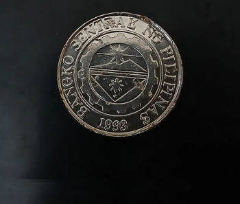 The Coin in the image is a 1 piso coin from Philippines dated 1993 - 2010